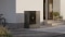 L'immagine mostra l'unità esterna Vitocal 200-A ie, installata a pavimento, situata a sinistra della porta d'ingresso di una casa unifamiliare dall'aspetto moderno.